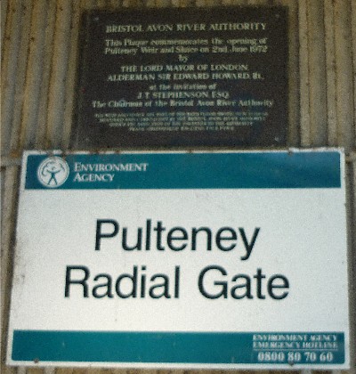 Plaque on flood control gate structure